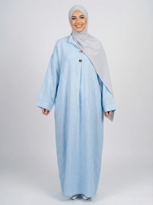 Femme souriante portant abaya bleu clair et hijab gris, mode modeste moderne Muneera
